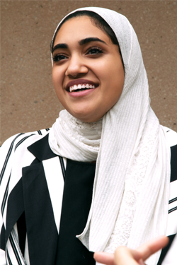 Mariam smiling in a conversation on UTSA's campus